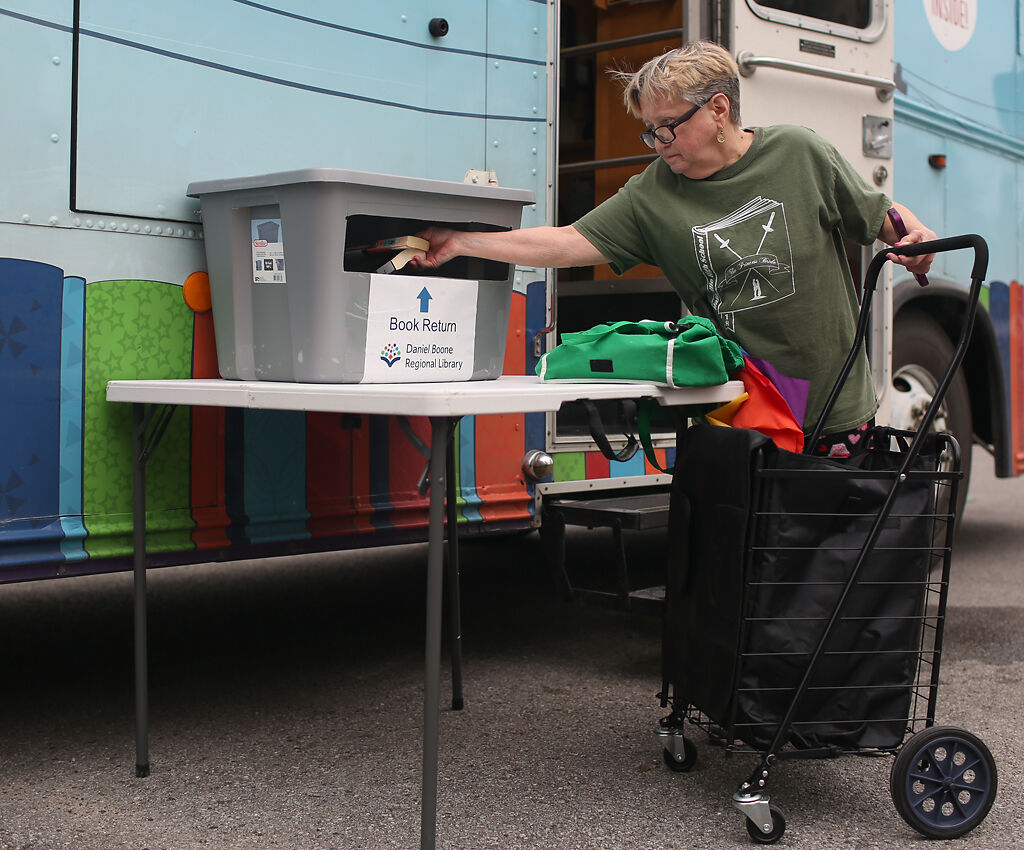 Hallsville resident Joy Sinclair drops off her previously checked out books